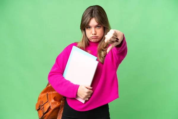Young Student Girl Isolated Chroma Key Background Showing Thumb Negative — Stock Photo, Image