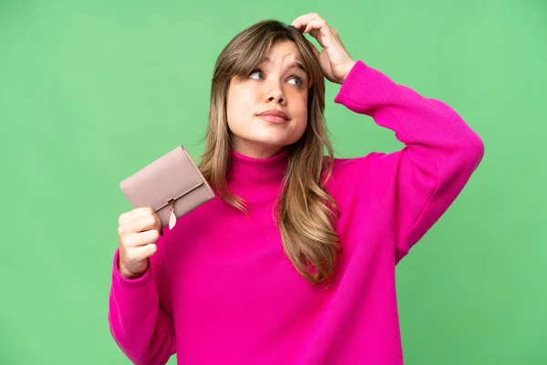 Young Girl Holding Wallet Isolated Chroma Key Background Having Doubts — Stock Photo, Image