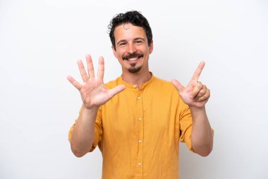 Young man with moustache isolated on white background counting seven with fingers