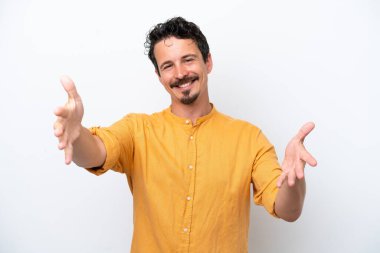 Young man with moustache isolated on white background presenting and inviting to come with hand