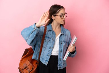 Young caucasian student woman isolated on pink background making stop gesture and disappointed