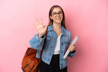 Pembe arka planda izole edilmiş beyaz bir kadın beş parmaklı sayım yapıyor.