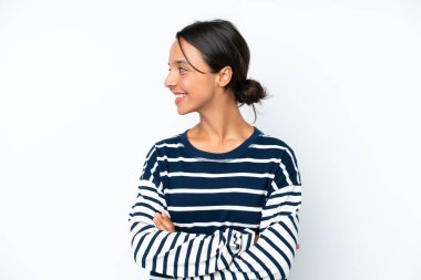 Young hispanic woman isolated on white background looking side