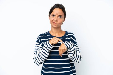Young hispanic woman isolated on white background making the gesture of being late