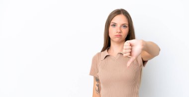 Young Lithuanian woman isolated on white background showing thumb down with negative expression