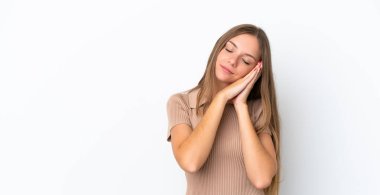 Young Lithuanian woman isolated on white background making sleep gesture in dorable expression