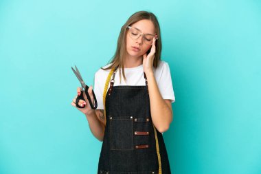 Young Lithuanian seamstress woman isolated on blue background with headache