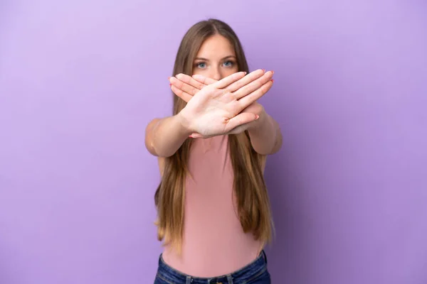 Young Lithuanian woman isolated on purple background making stop gesture with her hand to stop an act