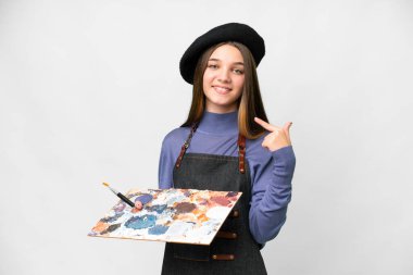 Young artist man holding a palette over isolated white background giving a thumbs up gesture