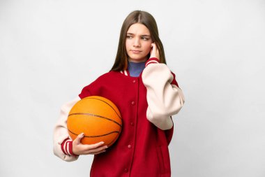 Teenager girl playing basketball over isolated white background frustrated and covering ears