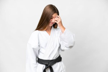 Teenager girl doing karate over isolated white background laughing