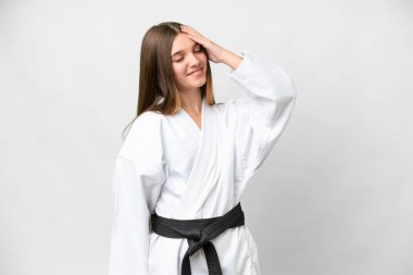 Teenager girl doing karate over isolated white background smiling a lot