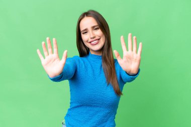 Young beautiful woman over isolated chroma key background counting ten with fingers