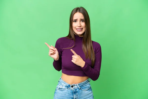 Young Beautiful Woman Isolated Chroma Key Background Frightened Pointing Side — Stockfoto