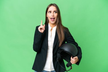 Young Asian woman with a motorcycle helmet over isolated chroma key background thinking an idea pointing the finger up