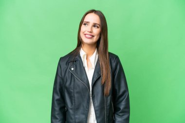 Young beautiful woman over isolated chroma key background thinking an idea while looking up