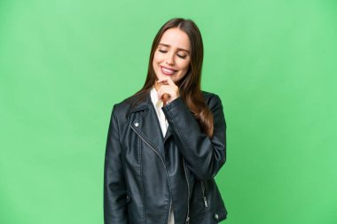 Young beautiful woman over isolated chroma key background looking to the side and smiling