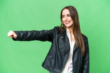 Young beautiful woman over isolated chroma key background giving a thumbs up gesture