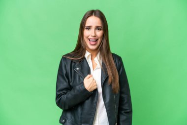 Young beautiful woman over isolated chroma key background with surprise facial expression