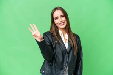 Young beautiful woman over isolated chroma key background happy and counting three with fingers