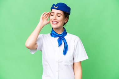Airplane stewardess over isolated chroma key background has realized something and intending the solution