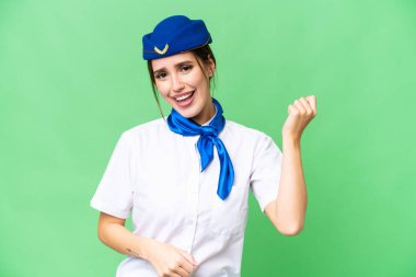 Airplane stewardess over isolated chroma key background making guitar gesture