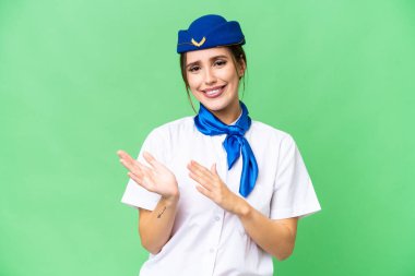 Airplane stewardess over isolated chroma key background applauding after presentation in a conference