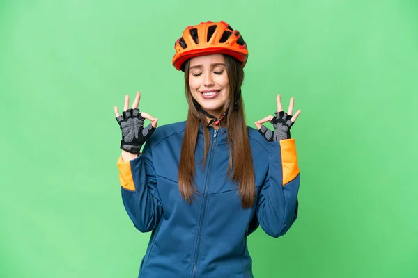 Young Cyclist Woman Isolated Chroma Key Background Zen Pose — Stockfoto