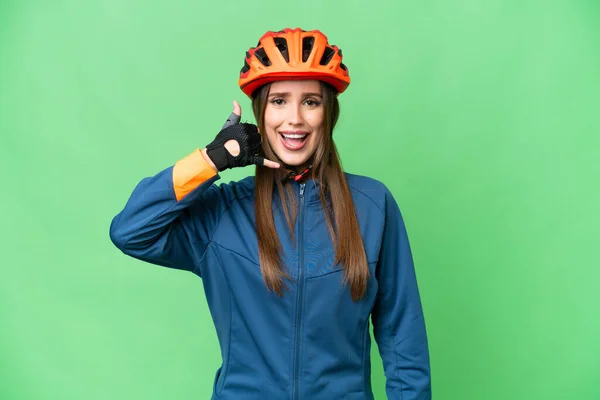 Young Cyclist Woman Isolated Chroma Key Background Making Phone Gesture — Stockfoto