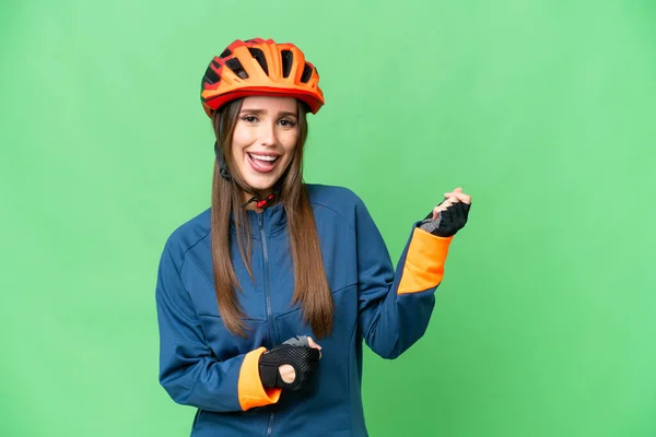 Young Cyclist Woman Isolated Chroma Key Background Making Guitar Gesture — Stockfoto