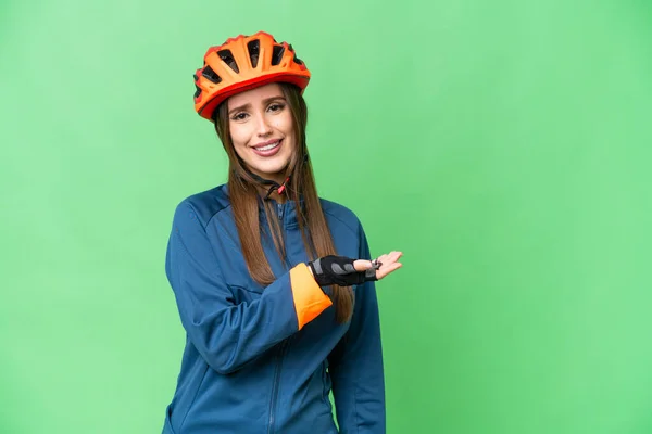 Young Cyclist Woman Isolated Chroma Key Background Presenting Idea While — Stockfoto