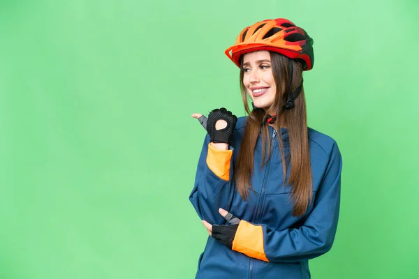 Young Cyclist Woman Isolated Chroma Key Background Pointing Side Present — 스톡 사진