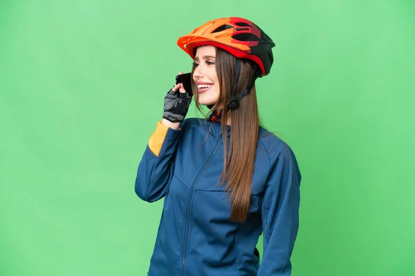 Young Cyclist Woman Isolated Chroma Key Background Keeping Conversation Mobile — 스톡 사진