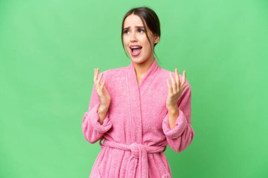 Young beautiful woman in a bathrobe over isolated chroma key background with surprise facial expression