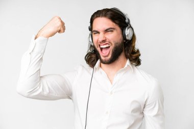Telemarketer man working with a headset over isolated white background doing strong gesture
