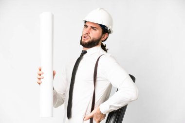 Young architect man with helmet and holding blueprints over isolated white background suffering from backache for having made an effort