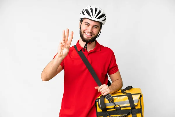 Young delivery man with thermal backpack over isolated white background happy and counting three with fingers