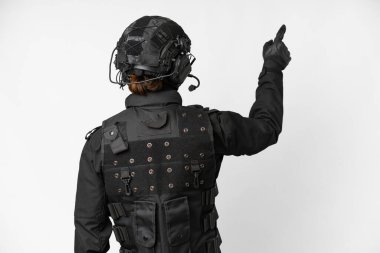 SWAT over isolated white background pointing back with the index finger