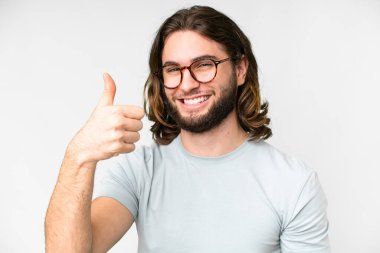 Young handsome man over isolated white background With glasses and with thumb up