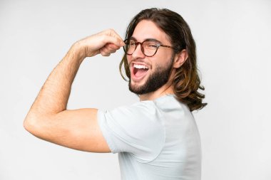 Young handsome man over isolated white background With glasses and celebrating a victory
