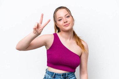 Young caucasian girl isolated on white background smiling and showing victory sign