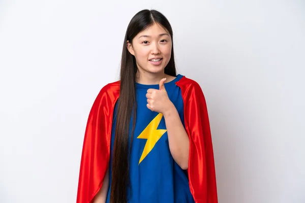 Super Hero Chinese woman isolated on white background giving a thumbs up gesture