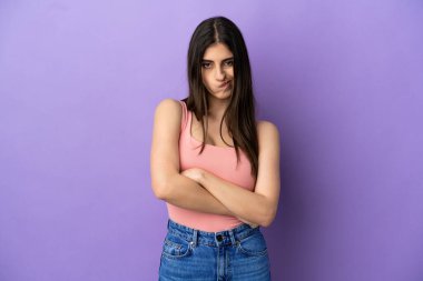 Mutsuz bir ifadeyle mor arka planda izole edilmiş beyaz bir kadın.