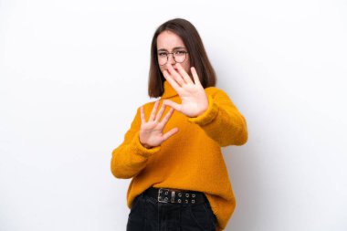 Young Ukrainian woman isolated on white background nervous stretching hands to the front