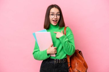 Young student Ukrainian woman isolated on pink background with surprise facial expression