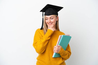 Young student caucasian woman isolated on white background looking to the side and smiling