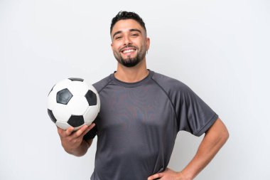 Arab young football player man isolated on white background posing with arms at hip and smiling