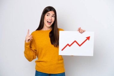 Young Brazilian woman isolated on white background holding a sign with a growing statistics arrow symbol and thinking