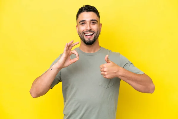 Young Arab Handsome Man Isolated Yellow Background Showing Sign Thumb — 스톡 사진