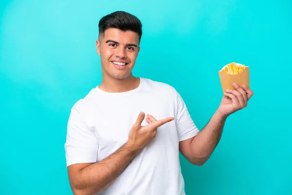 Young Caucasian Man Catching French Fries Isolated Blue Background Extending — 图库照片